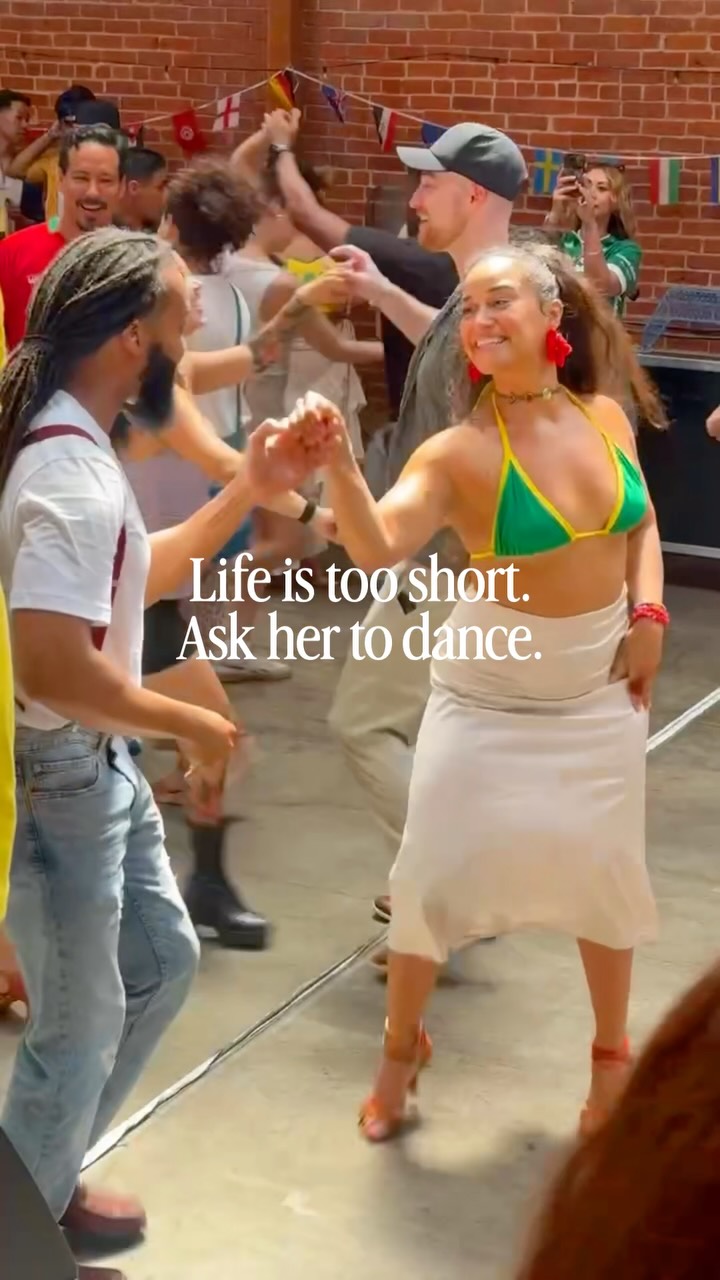 Cristina and her partner dancing among the outdoor crowd at Salsamba.